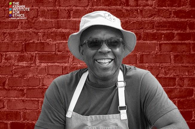 The Ethics of Now with Adriane Lentz-Smith. James Beard Award-winning chef and founder of Saltbox Seafood Joint Ricky Moore on Food as Care. Monday, November 7, 2022, 7:00pm, Durham Arts Council. dukeethics.org. Kenan Institute of Ethics at Duke University logo. Image of Ricky Moore in t-shirt, apron, and Saltbox bucket hat, smiling, in black and white against a red brick background. The Ethics of Now with Adriane Lentz-Smith. James Beard Award-winning chef and founder of Saltbox Seafood Joint Ricky Moore on Food as Care. Monday, November 7, 2022, 7:00pm, Durham Arts Council. dukeethics.org. Kenan Institute of Ethics at Duke University logo. Image of Ricky Moore in t-shirt, apron, and Saltbox bucket hat, smiling, in black and white against a red brick background.